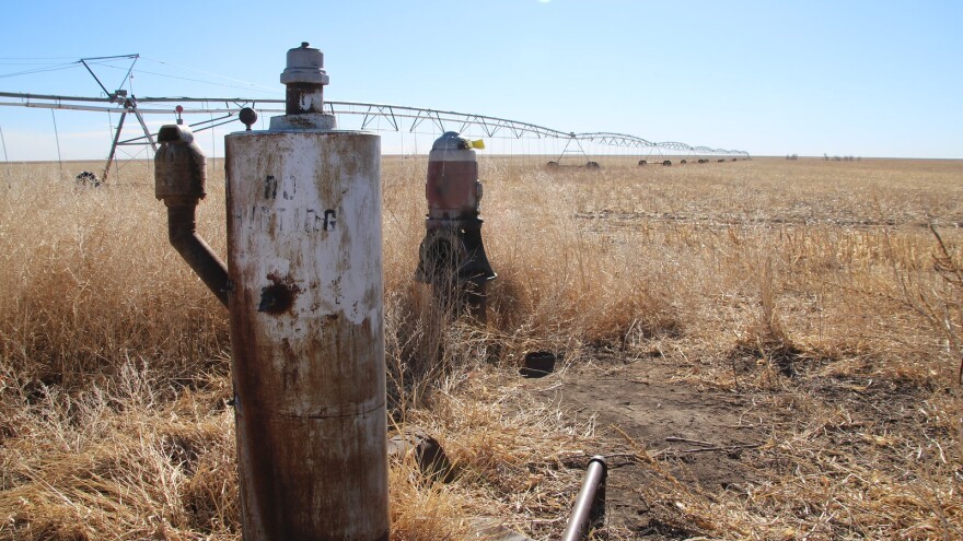 An old water well stands next to a center pivot irrigation system in a Morton County field. This southwest corner of Kansas has been experiencing extreme drought since last fall.