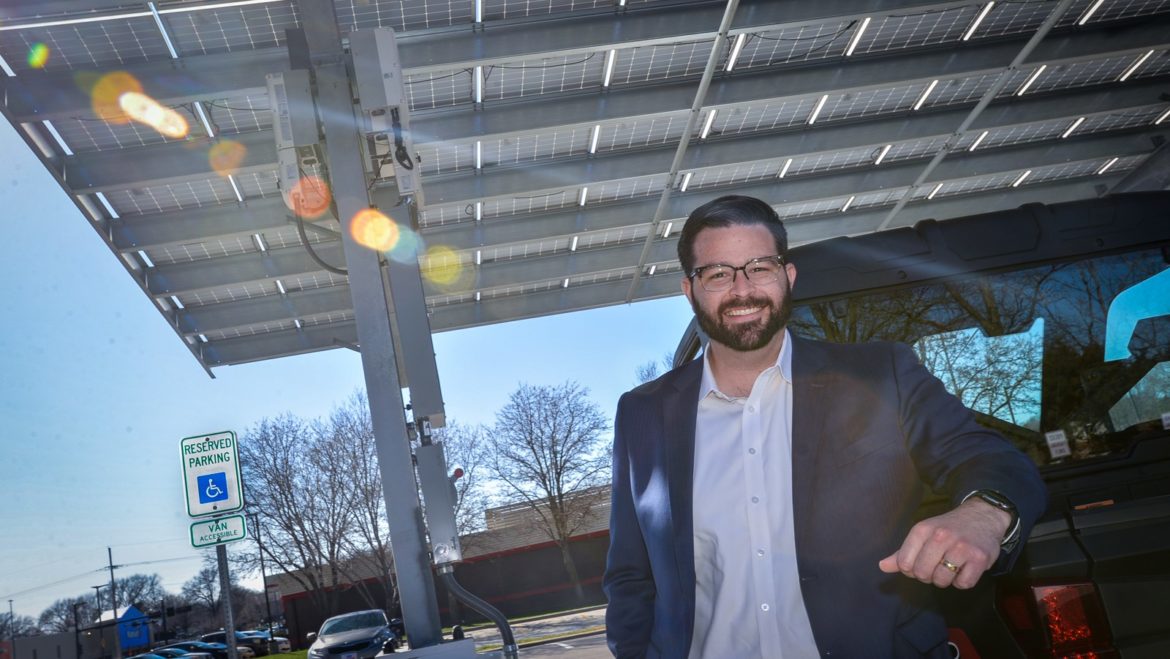 Roeland Park Mayor Mike Kelly shows off the solar panel array that doubles as a parking cover at City Hall.